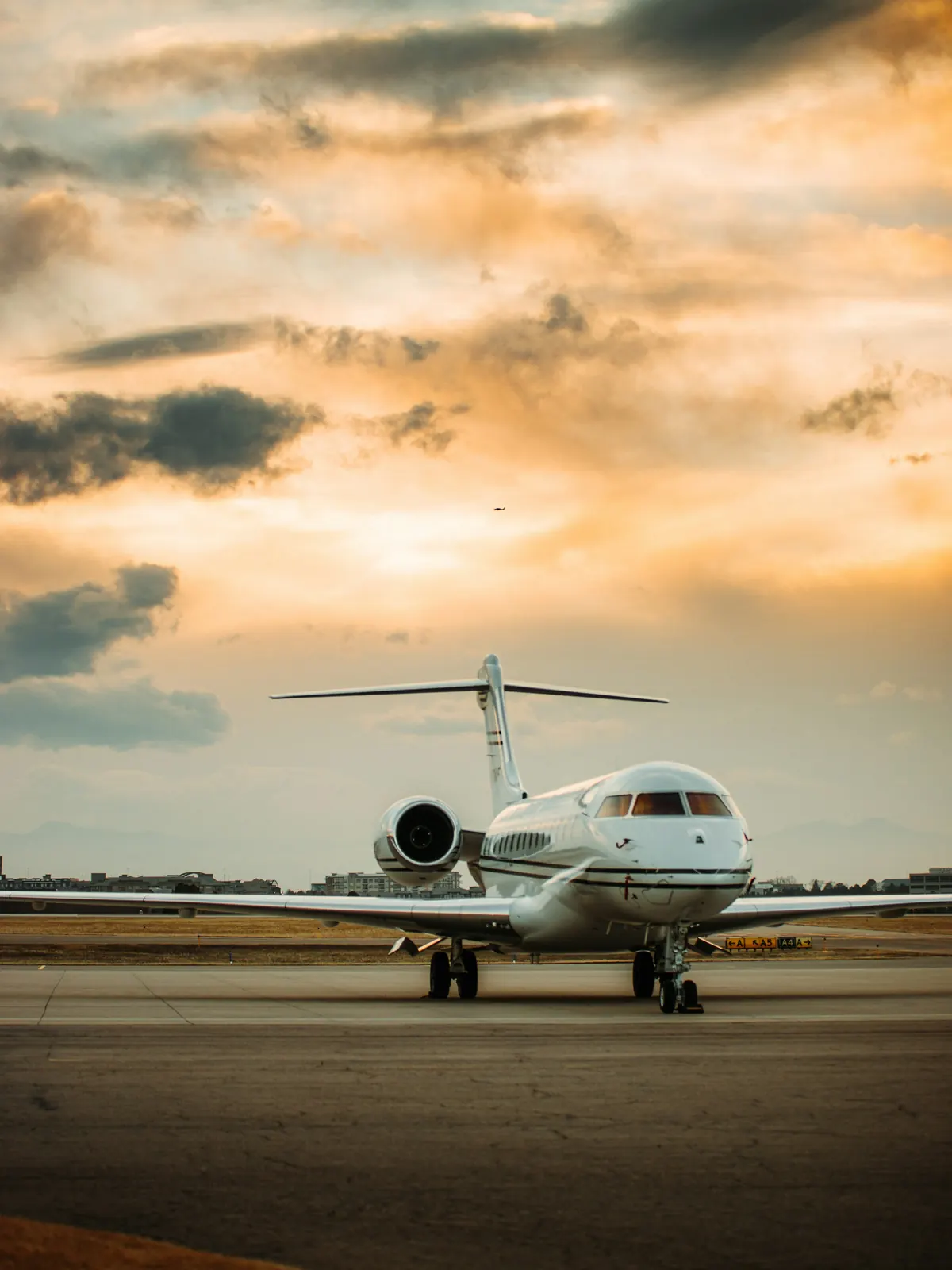 A large cabin jet silhouetted against a sunset
