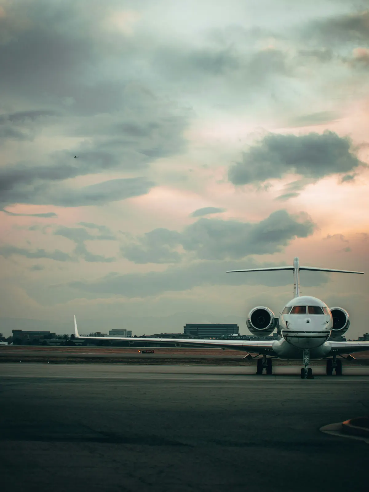 A business jet on the runway at dusk