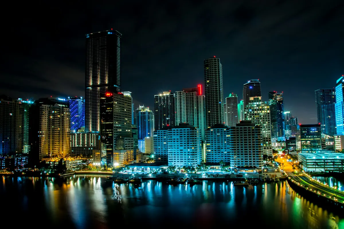 Miami’s skyline lit up across the water at night